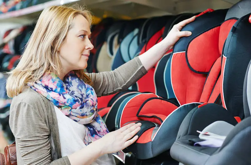 Woman choosing baby car seat